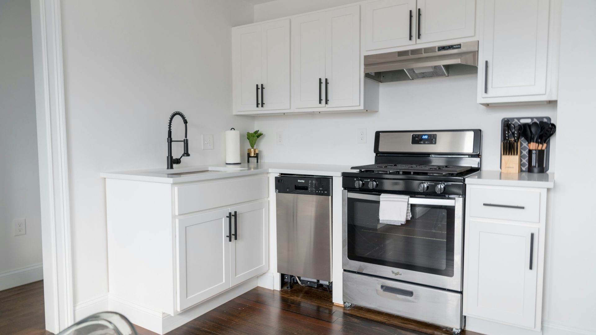 white wooden kitchen cabinet and white microwave oven